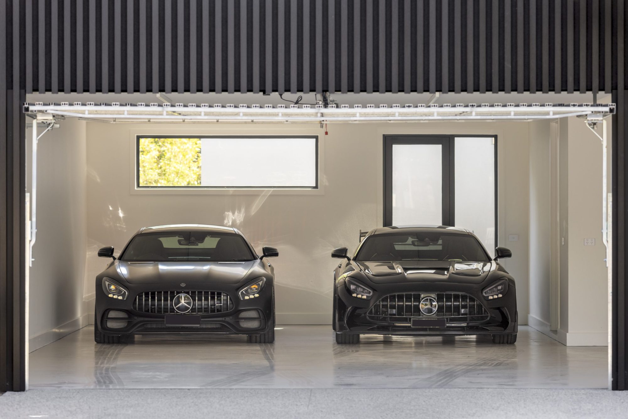 Double garage with black battened walls, Scheele Residence Surrey Hills