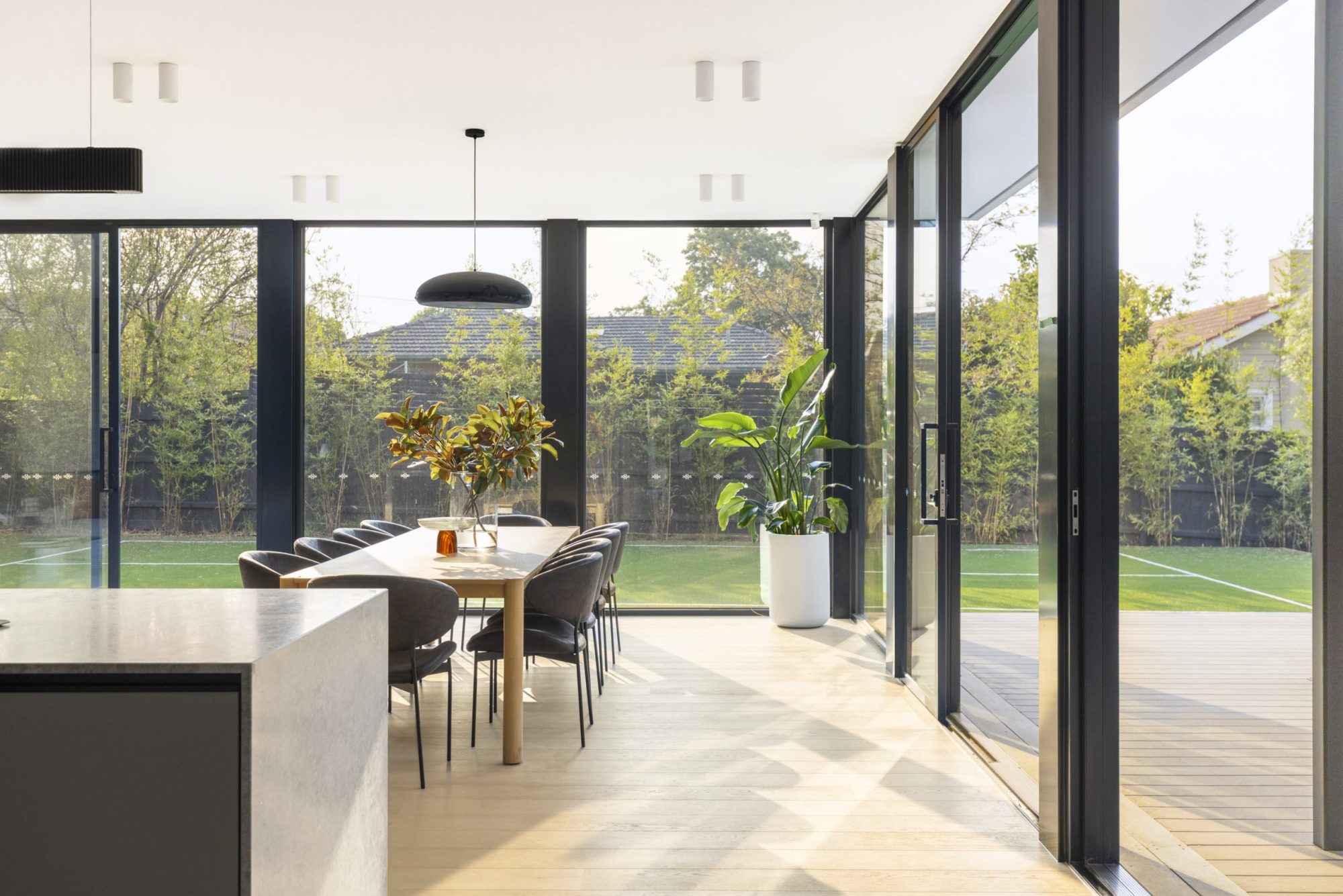 Dining area with full-height glazing to the garden, Surrey Hills knockdown rebuild by Bluestar