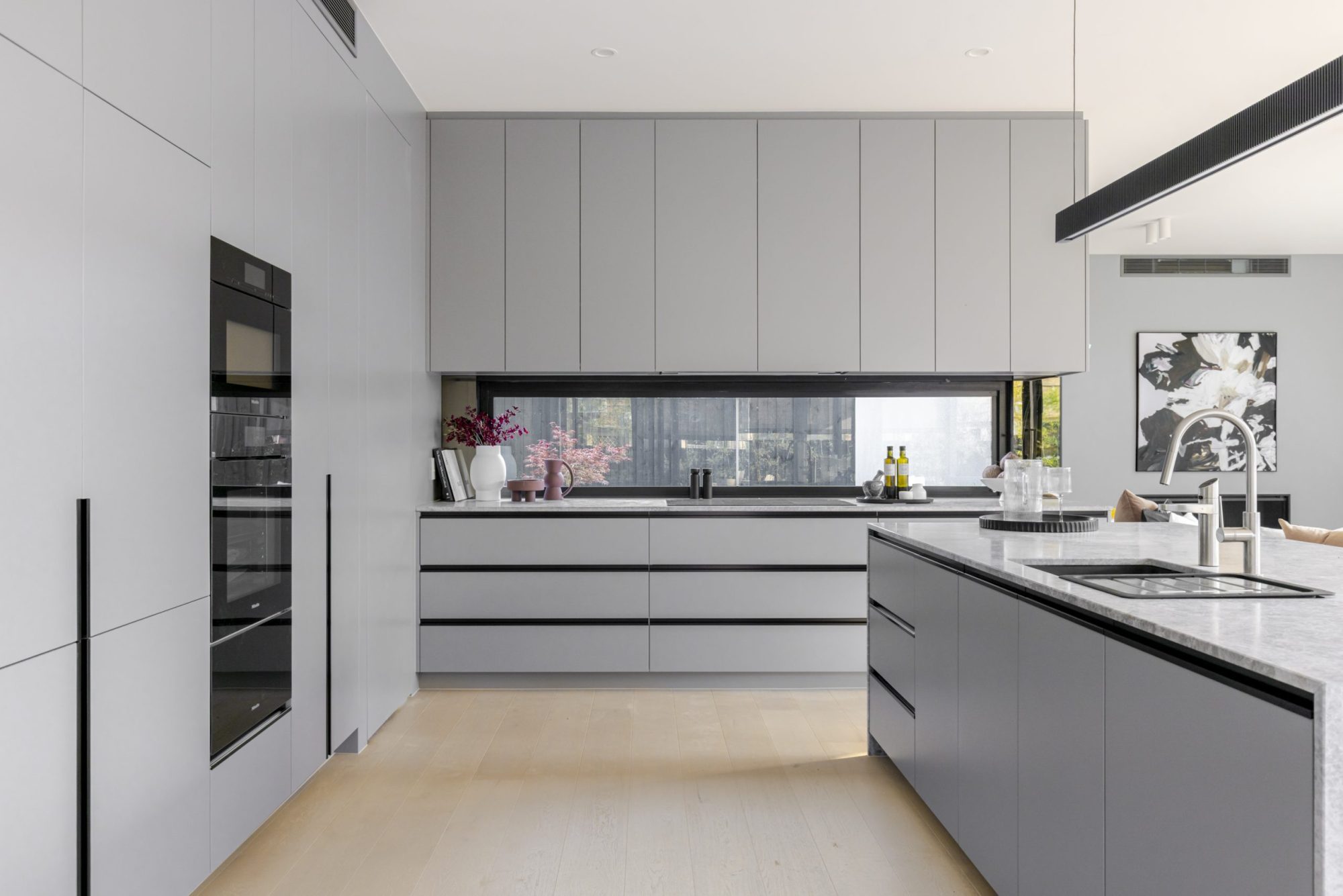 Kitchen with grey cabinetry and integrated appliances, Scheele Residence Surrey Hills