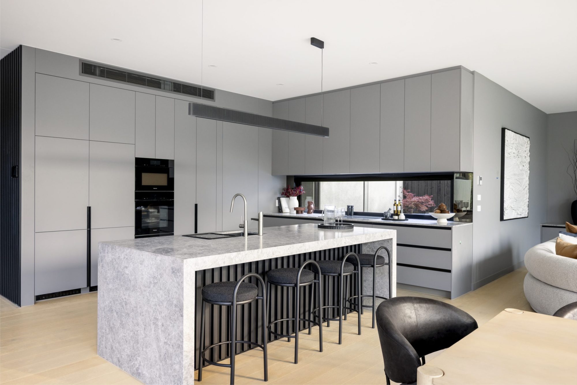 Marble island kitchen with bar seating, Surrey Hills knockdown rebuild by Bluestar